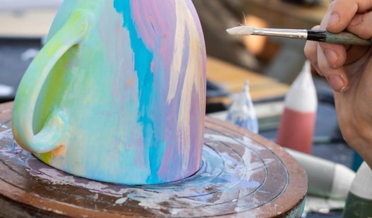 How do you paint with acrylic on ceramic mugs and plates to make it dishwasher safe?